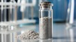 © hathairat - Close-Up Shot of Europium Powder in Glass Vial on Laboratory Table