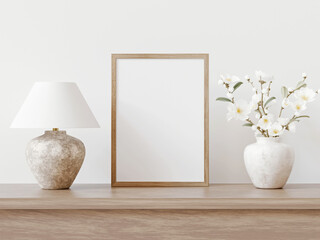 Aufkleber - Small vertical wooden frame mockup in traditional light interior. Classical shelf decoration with lamp and blooming branches in marble vase. 3d rendering.