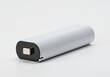 © Si - White cylindrical battery on a plain white background