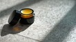 © THESUN - jar of lip balm under sunlight.