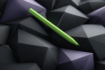 Poster - Green pen placed on textured black and purple geometric shapes in an artistic display