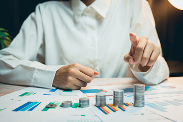 Poster - Concept of saving money. Business Person Analyzing Financial Data with Coins and Graphs in Office Environment for Investment Strategy