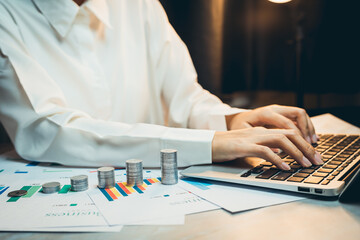 Poster - concept of saving money. business analyst working on financial reports with coins and laptop in mode
