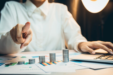 Poster - Concept of saving money. Business Professional Analyzing Financial Data and Growth Trends with Coins on Desk in Modern Office Environment