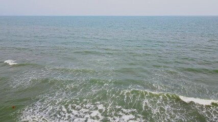 Wall Mural - Drone footage of vast blue sea under a misty sky during day in Vung Tau city, Vietnam
