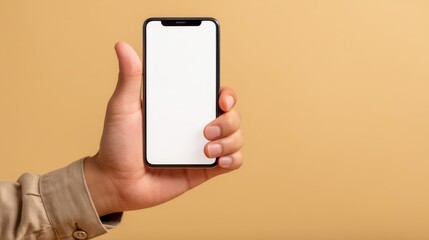 A person holds a smartphone with a blank display in front of a solid beige background. The focus is on the device with a clear view of its screen, showcasing a minimalist aesthetic