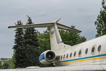 Fototapete - close-up image of a blue and yellow passenger jet engine in motion, visible part of the plane with w