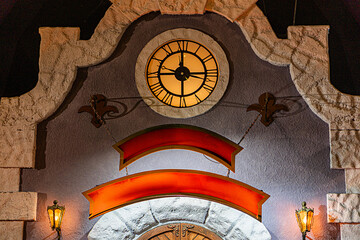 Fototapete - christmas clock tower with curved entrance, stylized fish motif, circular window or light, wall-moun