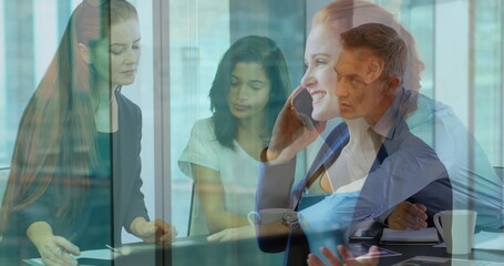 Poster - Image of caucasian businesswoman having call over diverse businesspeople working in office