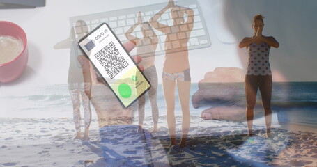 Poster - Image of caucasian woman with smartphone over caucasian women at beach