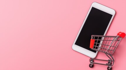 Poster - Shopping Cart Next to Smartphone on Pink Background for Online Shopping Concept and Digital Marketplace