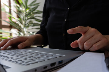 Poster - Businesswoman working on her laptop, while pointing