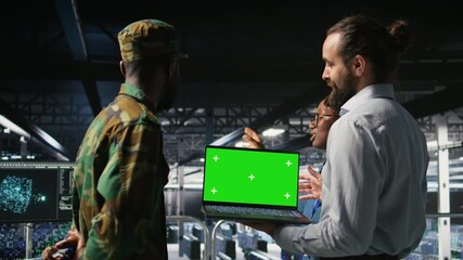 Poster - Military command center engineering team using chroma key notebook. Army IT expert and coworkers in data center using green screen laptop to defend networks against threats, camera A