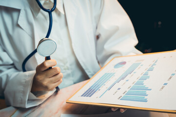 Poster - Medical concept. Doctor in White Coat Analyzing Medical Chart with Stethoscope and Graphs in a Medical Environment