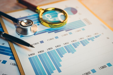 Poster - Health care concept. Medical Analysis with Stethoscope, Magnifying Glass, and Data Charts on a Desk for Research and Interpretation