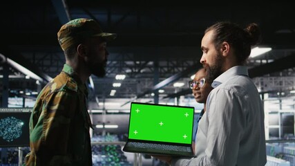 Poster - Army engineering team in command center server hub using mockup laptop to install and maintain IT systems. Military data center admins overseeing information systems with chroma key notebook, camera A