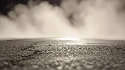 Poster - A view of a wet asphalt ground with fog and bright light in the background