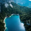 © zen - aerial view of mountain lake, turquoise water, pine forest surrounding