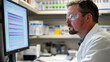 © Soulc - Scientist Analyzing Data on Computer in Laboratory