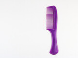 One purple plastic comb isolated - on white background