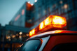 © Health Studio - A close-up of a police car with bright flashing lights at dusk in an urban setting.