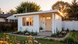 © Cherrisa - Accessory dwelling unit. Charming small house with garden at sunset.