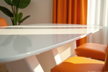 Poster - A simple yet elegant setting with a white table and orange chairs placed in front of a window, perfect for a cozy breakfast or intimate gathering
