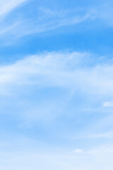 Wall Mural - blue sky background and white clouds soft focus, space in the middle, vertical shape.