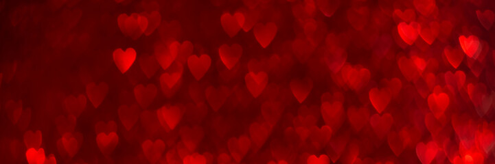 Wall Mural - Red hearts, sparkling glitter bokeh background banner, valentines day abstract defocused texture header.