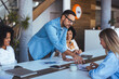 © Dragana Gordic - Professional Team Collaborating in Modern Office Setting During a Business Meeting