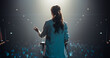© Gorodenkoff - Businesswoman Walking Out on Stage to Give a Talk at a Global Finance Summit. Audience Listening to Her Insightful Talk. Speaker Standing with Her Back to Camera While Making a Motivational Speech