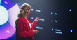 © Gorodenkoff - Beautiful Adult Female in a Red Suit Making a Passionate Lecture with a Big Screen Showing Different Analytical Data in the Background. Representative Sharing a Company Earning Report to Shareholders