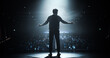 © Gorodenkoff - Anonymous Man Standing Under a Spotlight on Stage in Front of a Sold-Out Audience. Motivational Speaker or a Stand Up Comedian Making an Unforgettable Performance