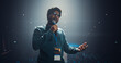© Gorodenkoff - Indian Entrepreneur in Glasses Shares an Insightful Talk on Technology and Leadership at a Professional Business Conference. Diverse Multiethnic Guests Sitting in a Dark Auditorium