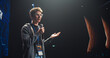 © Gorodenkoff - Young Speaker with Expertise in Business Development Coaching a Group of Specialists During a Presentation at an International Technology Conference. Man Dressed in Casual Clothes and Wearing Glasses