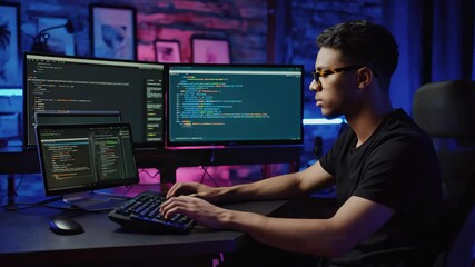 Programming session in a modern workspace with multiple screens