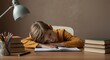 © Vyatcheslav - Young boy resting his head on books while studying at a desk