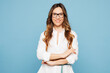 © ViDi Studio - Young smiling happy successful employee business woman corporate lawyer wear shirt classic formal clothes glasses work in office look camera isolated on pastel light blue background studio portrait.