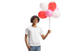 © Ljupco Smokovski - African american guy smiling and holding a bunch of balloons