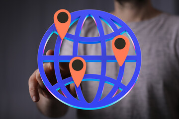 Poster - Person interacting with a 3D globe showing multiple location points, symbolizing global reach or network.