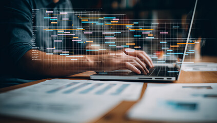 Business professional analyzing big data visualization on laptop computer screen