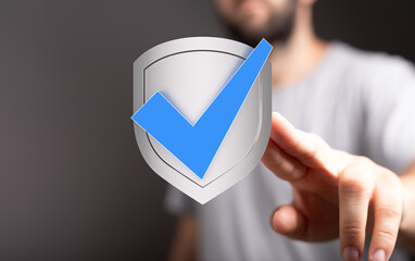 Aufkleber - High-quality image of a hand holding a shield with a checkmark, representing security and approval.