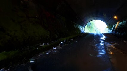 Aufkleber - Dark tunnel with graffiti and moss, leading to light at the end.