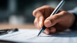 © Vitalii - Hand holding a pen while completing a checklist on paper, illustrating documentation, organization, or evaluation process