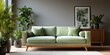 © Alexander Chaykin - A modern green sofa in a minimalistic room decorated with plants.