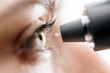 © wedmoments.stock - A woman measures her eye pressure with a modern portable tonometer in close-up. Concept of ophthalmologic diagnosis and treatment.