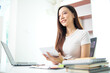 © thatinchan - Beautiful Asian business woman starting her SME business using her home as an office or Home Office to save on start up costs. Portrait start up SME business Asian business woman inside Home Office