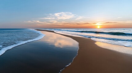 Wall Mural - Waves gently lap at the shoreline as the sun sets on the horizon, casting warm colors in the sky. The beach is serene and untouched, inviting tranquility and peace.