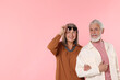 © New Africa - Senior couple in stylish outfits on pink background, space for text