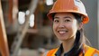 © anatolii - Skilled construction worker smiles confidently at a bustling construction site during daylight hours